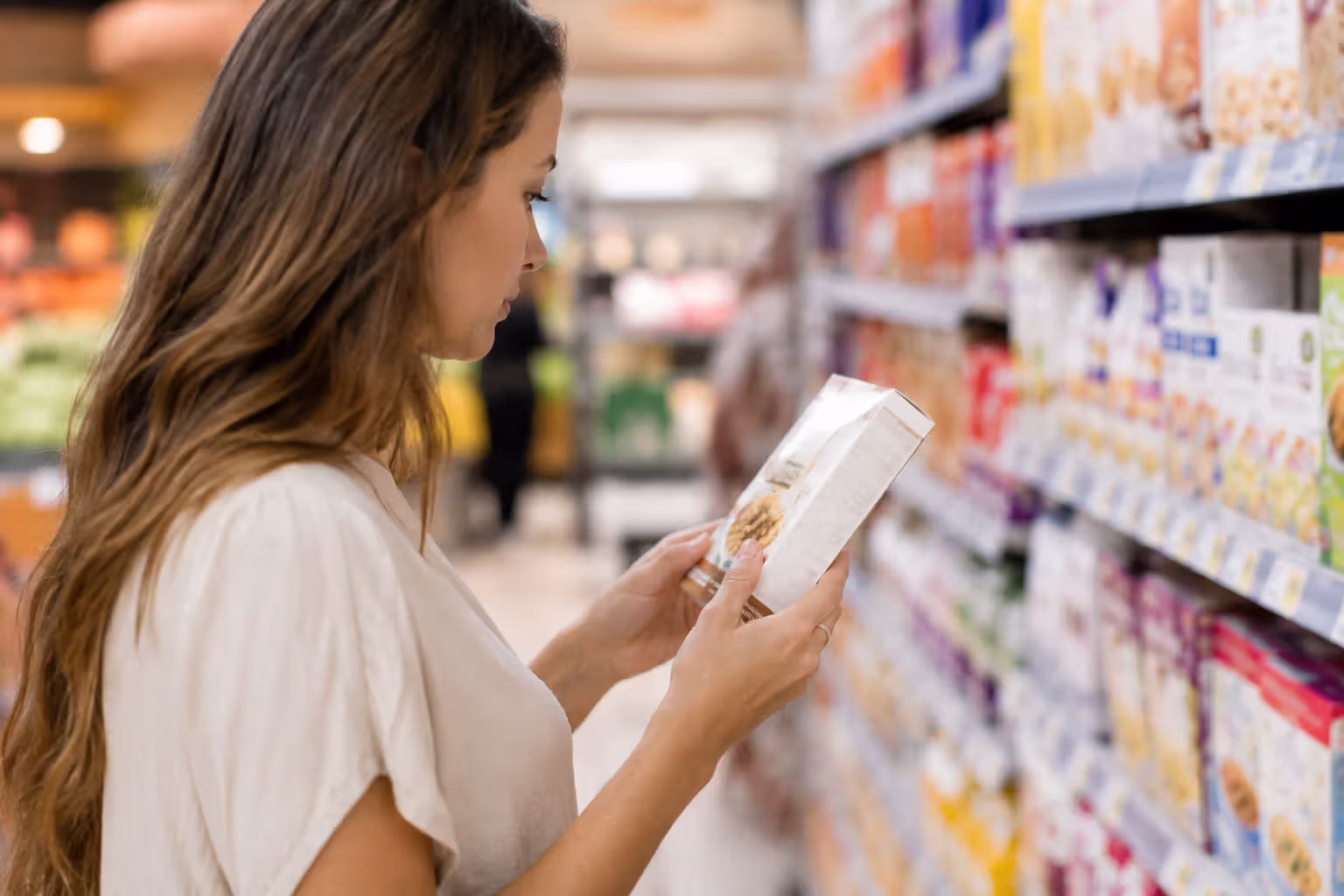 Person reading nutrition facts label on food package